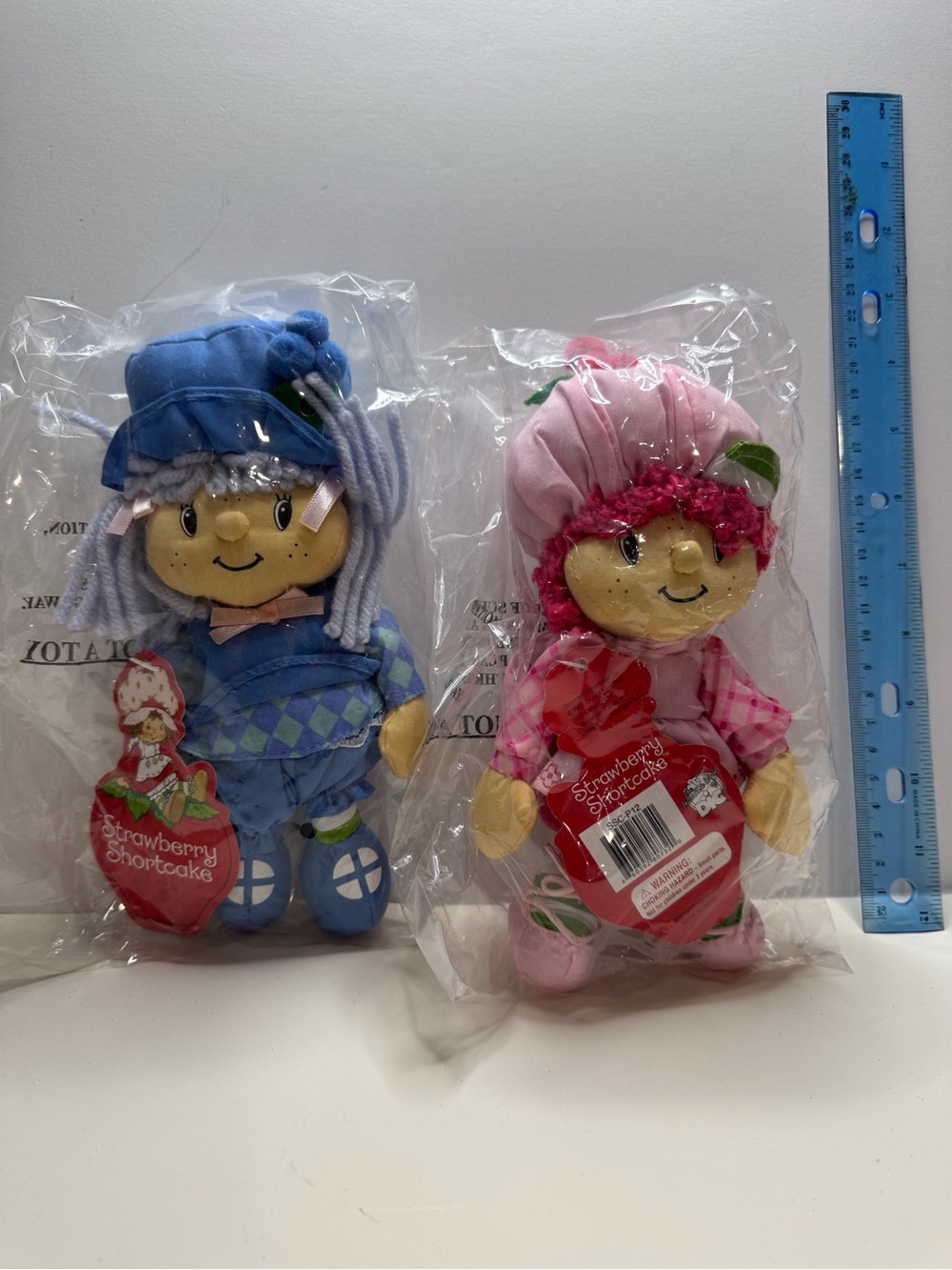Set of two Strawberry Shortcake dolls in original packaging.